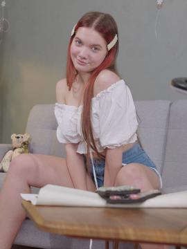 Vivi is a sexy teen with great tits, long legs and an incredibly tight pussy that she fingers upside down on a couch. — photo 7 of 16