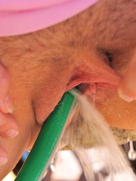 Danielle plays with the water hose — photo 4 of 15